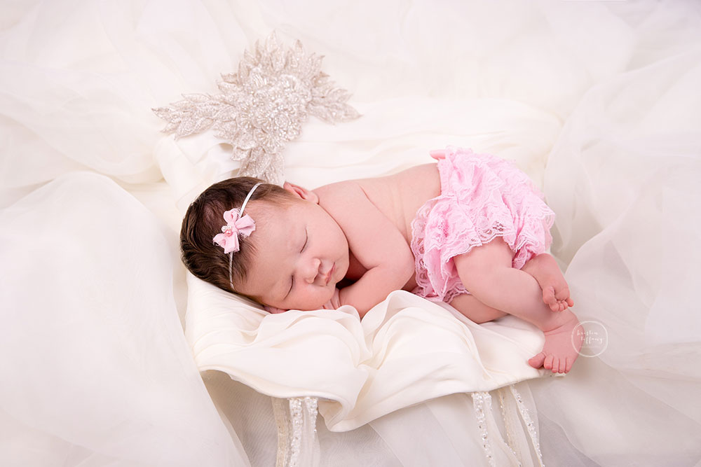 a photo of a baby girl at her newborn photo session