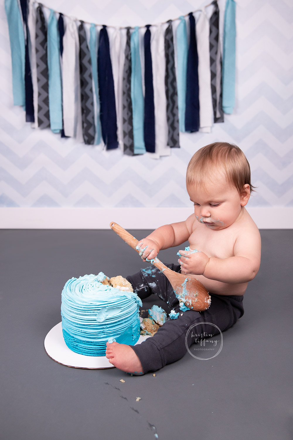 a photo of a baby boy at his cake smash photo session