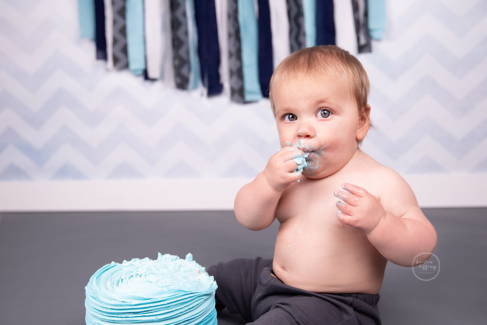 a photo of a baby boy at his cake smash photo session