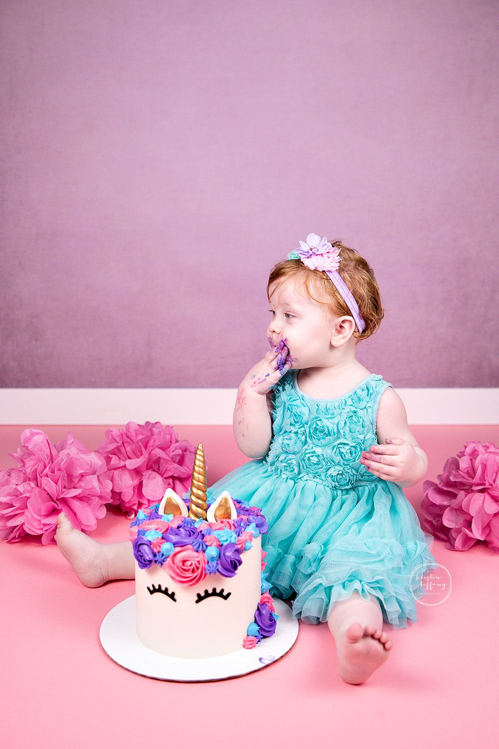 a photo of a baby girl at her cake smash photo session