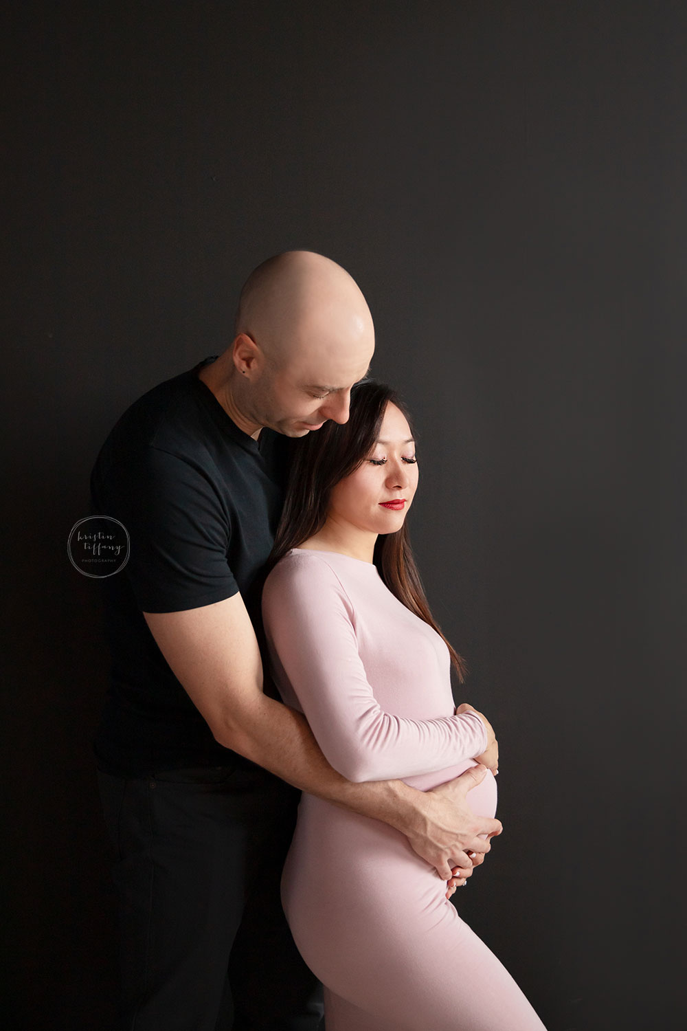 a maternity photo of an expecting mom and her husband at her maternity photoshoot