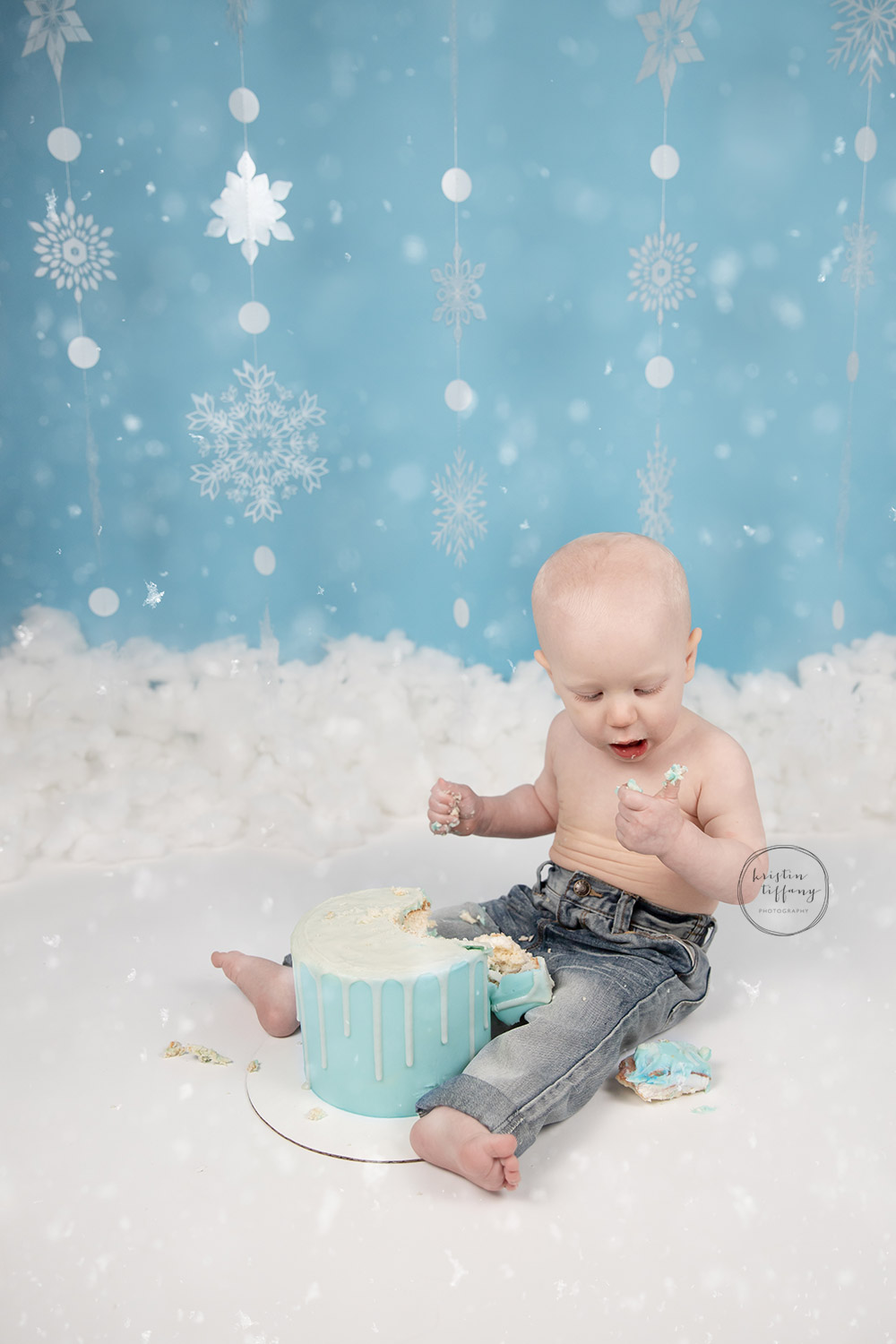 a photo of a baby boy at his cake smash photo shoot