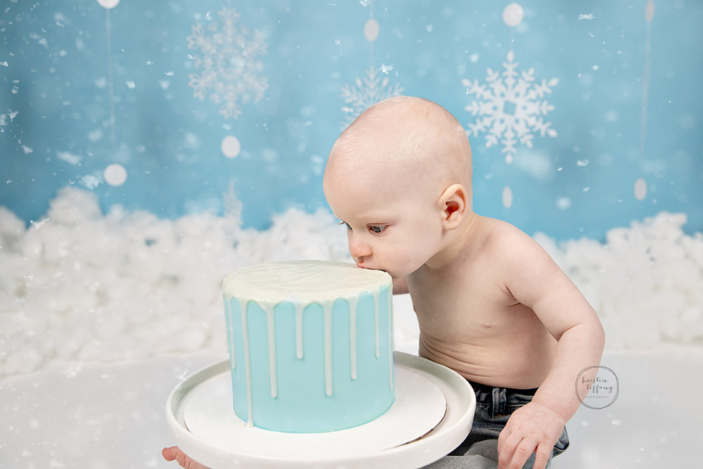 a photo of a baby boy at his cake smash photo shoot