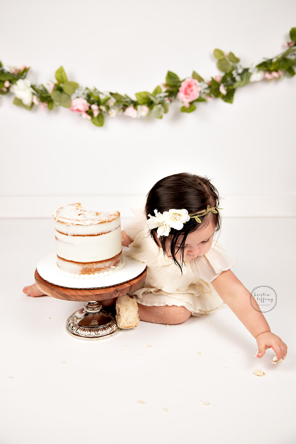 a photo of a baby girl at her cake smash session