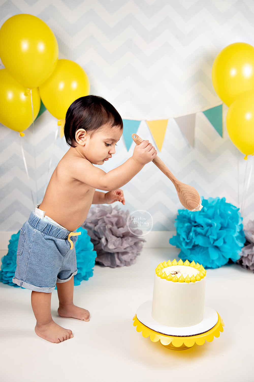 a photo of a baby boy at his cake smash session