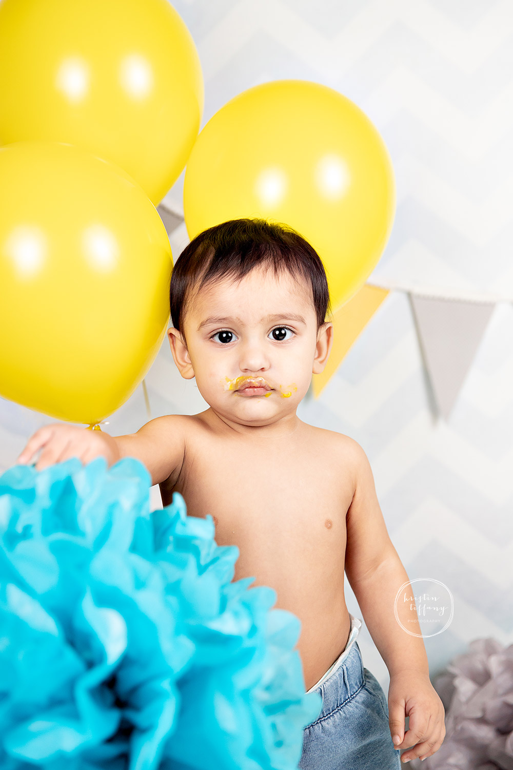 a photo of a baby boy at his cake smash session