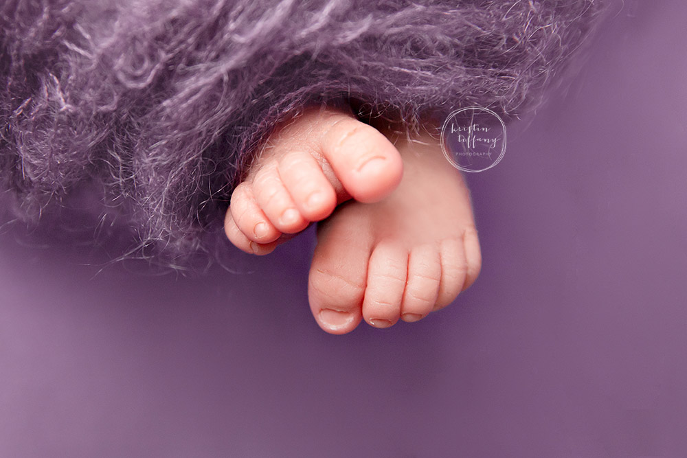 a photo of a baby girl 's feet at her newborn photo session