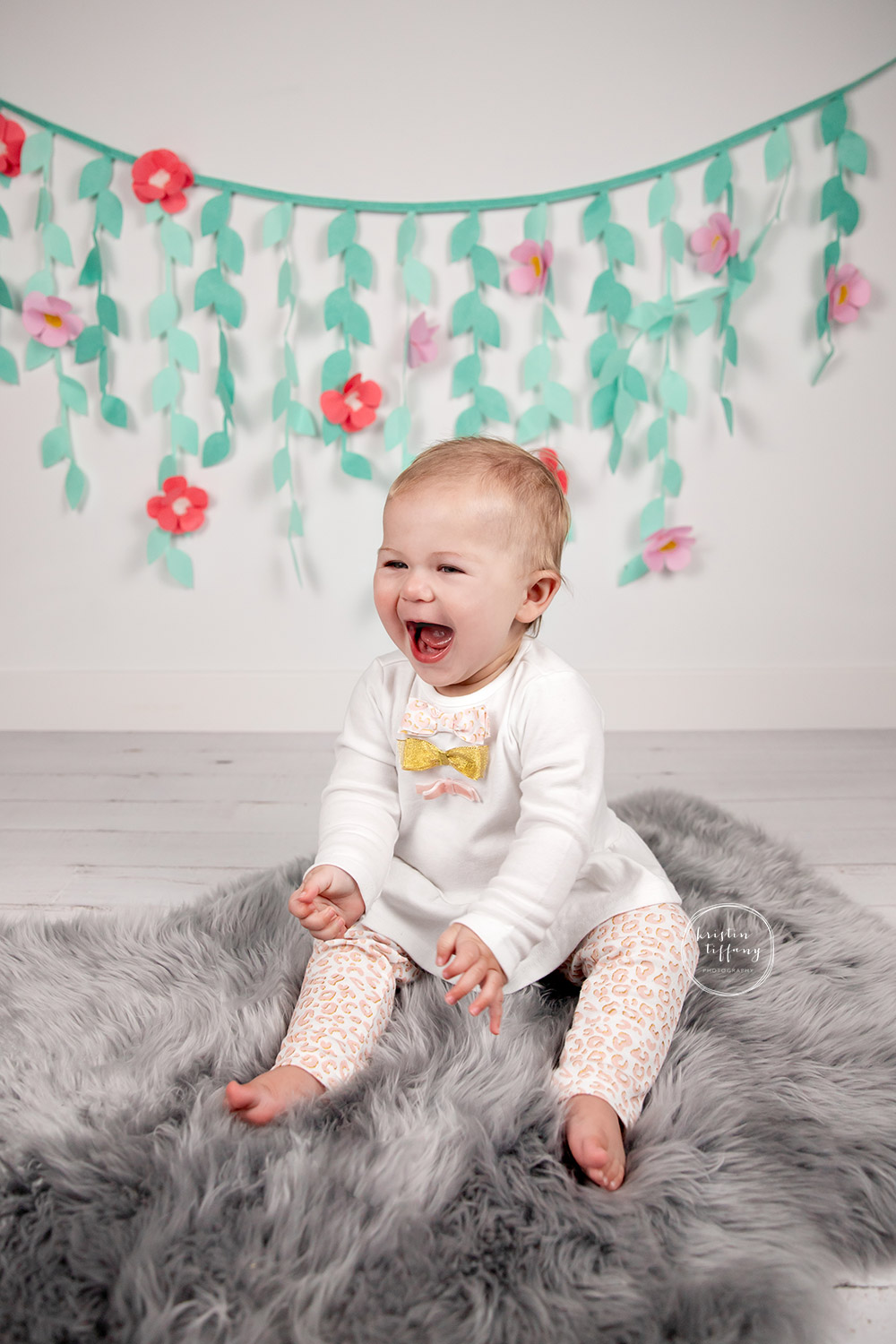 a photo of a baby girl at her cake smash photoshoot