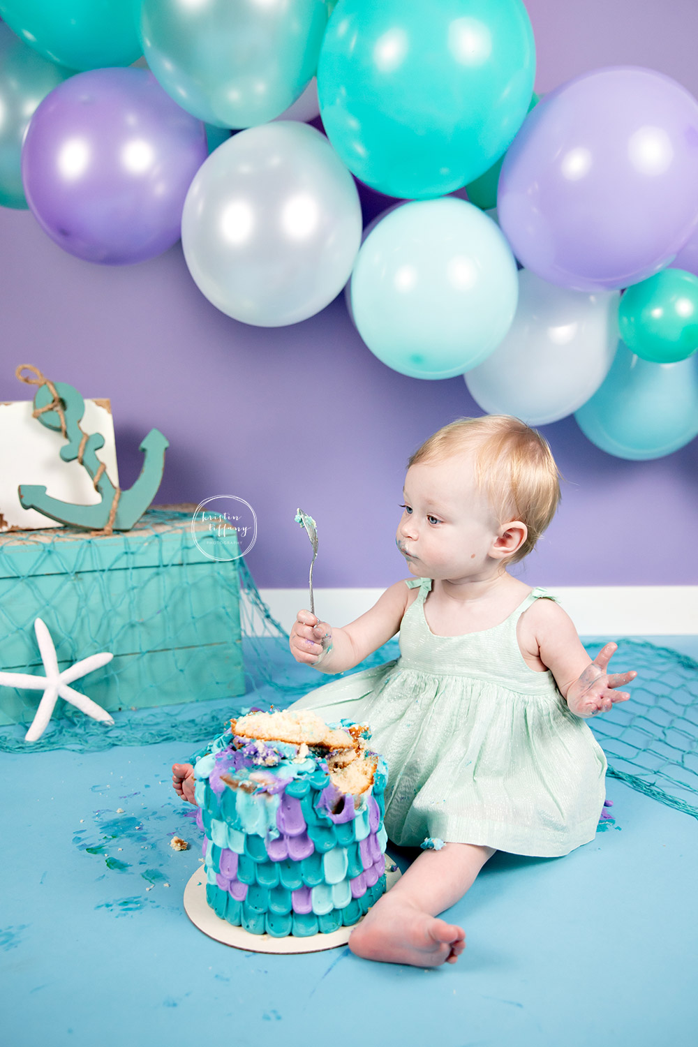 a photo of a baby girl at a cake smash session with Kristin Tiffany Photography