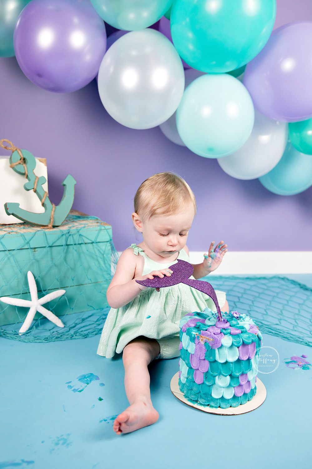 a photo of a baby girl at a cake smash session with Kristin Tiffany Photography